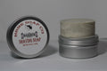 Shaving soap container with lid on a gray background