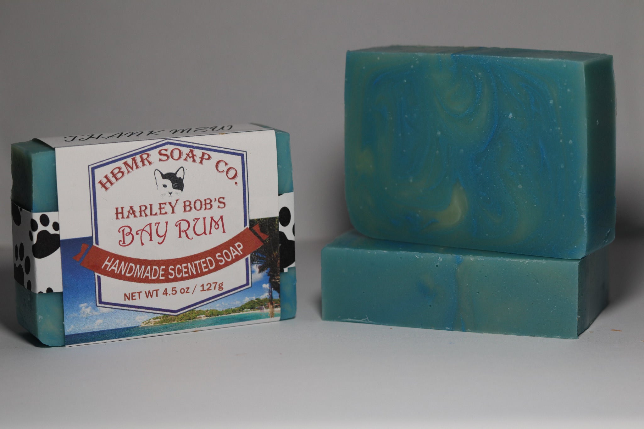 Teal soap bar with packaging labeled 'Harley Bob's Bay Rum' on a gray background