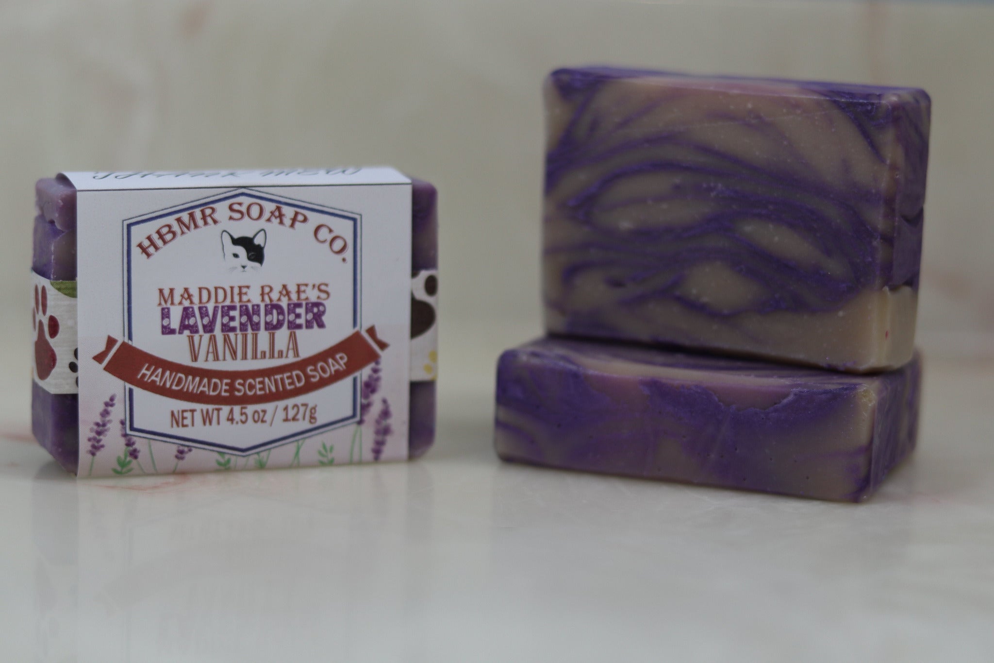 Handmade lavender vanilla soap with packaging on a white background