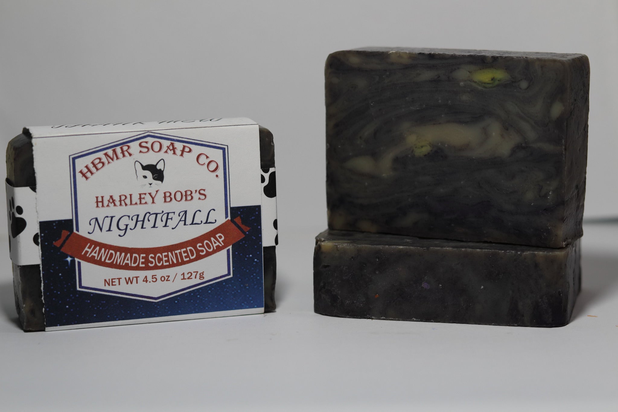 Two bars of soap, one with a label for HBMR Soap Co. and the other unscented, on a gray background.