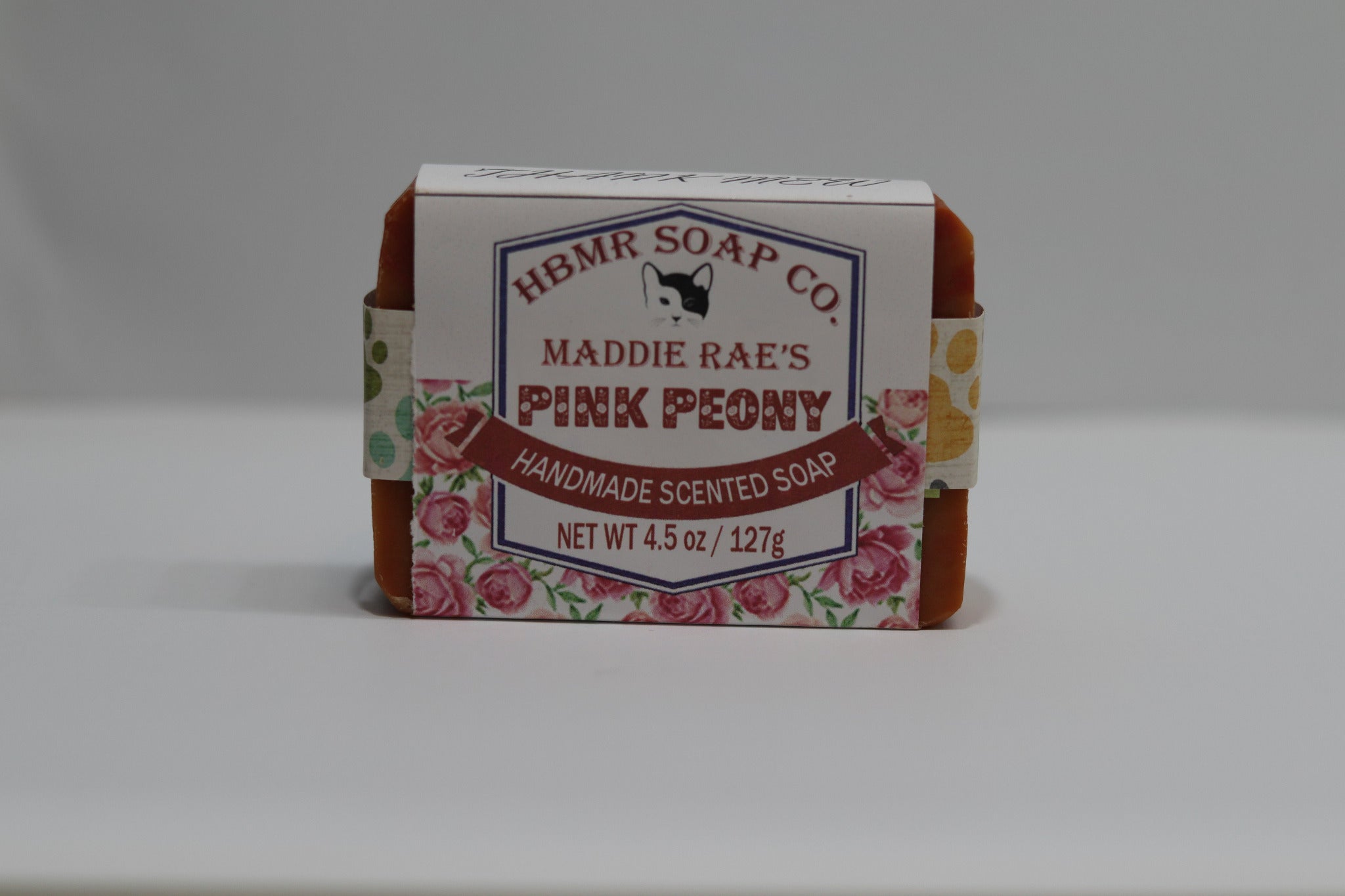 Handmade scented soap bar with packaging labeled 'HBMR Soap Co. Maddie Rae's Pink Peony' on a white background.