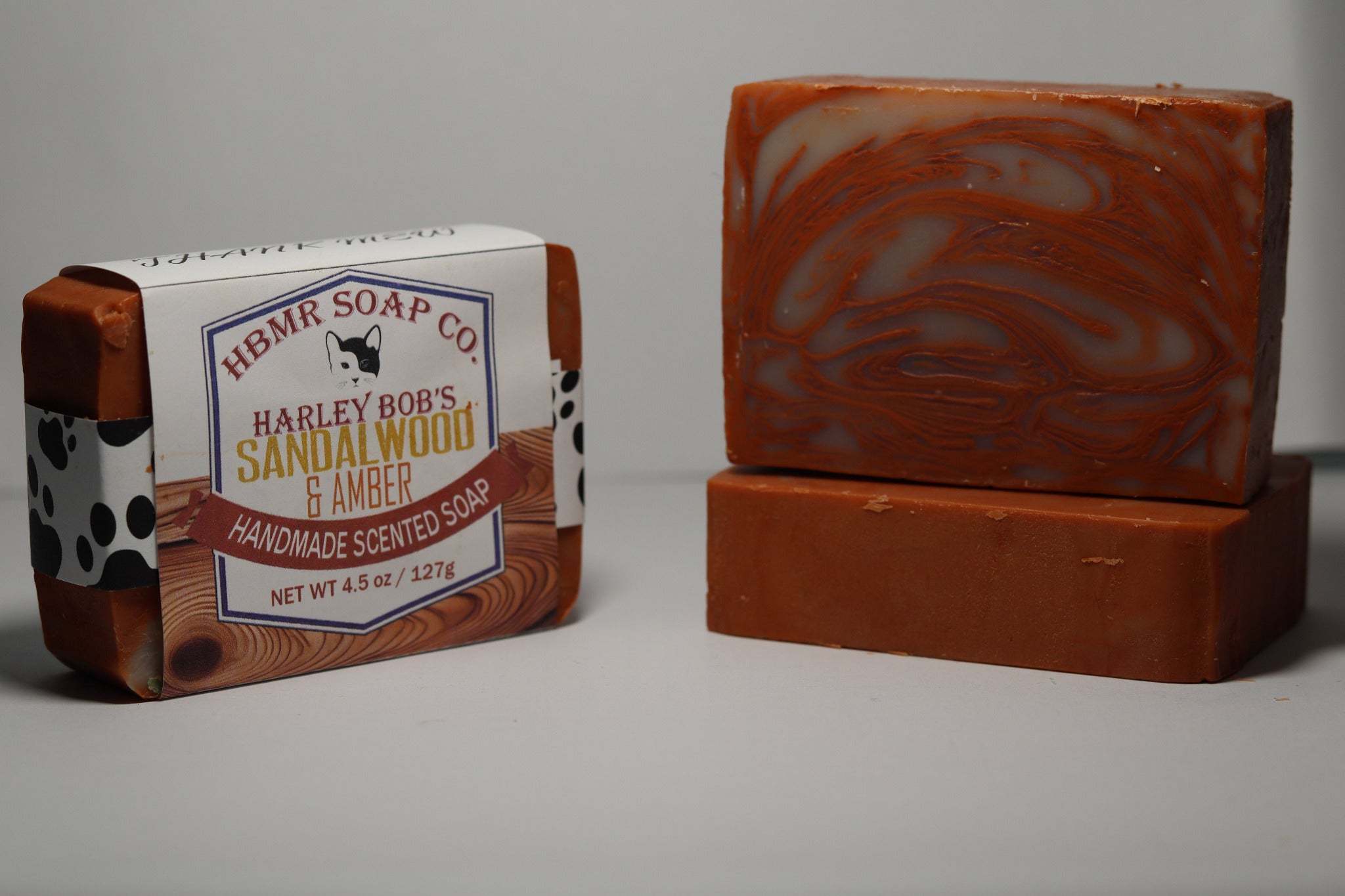 Bar of soap with packaging labeled 'HBMR Soap Co' on a gray background